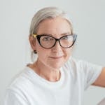 An Elderly Woman in White Shirt Wearing Eyeglasses